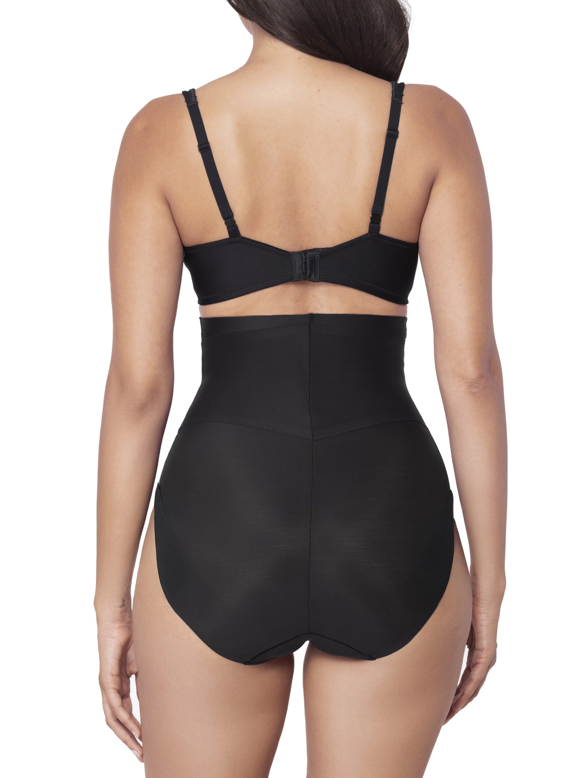 Woman wearing a black shapewear brief on a white background