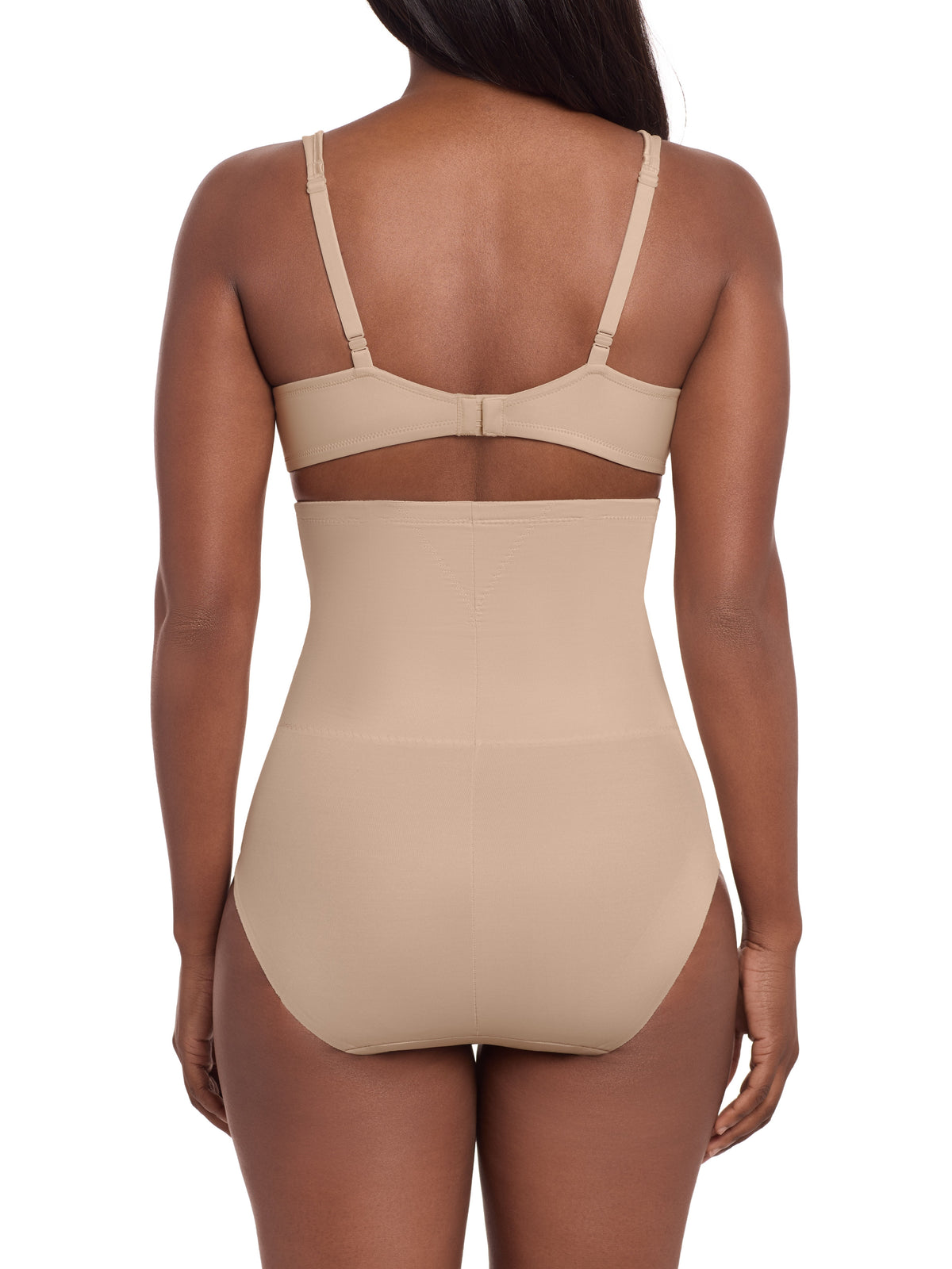 a woman wearing a beige high waisted tummy control brief control top panty miraclesuit shapewear