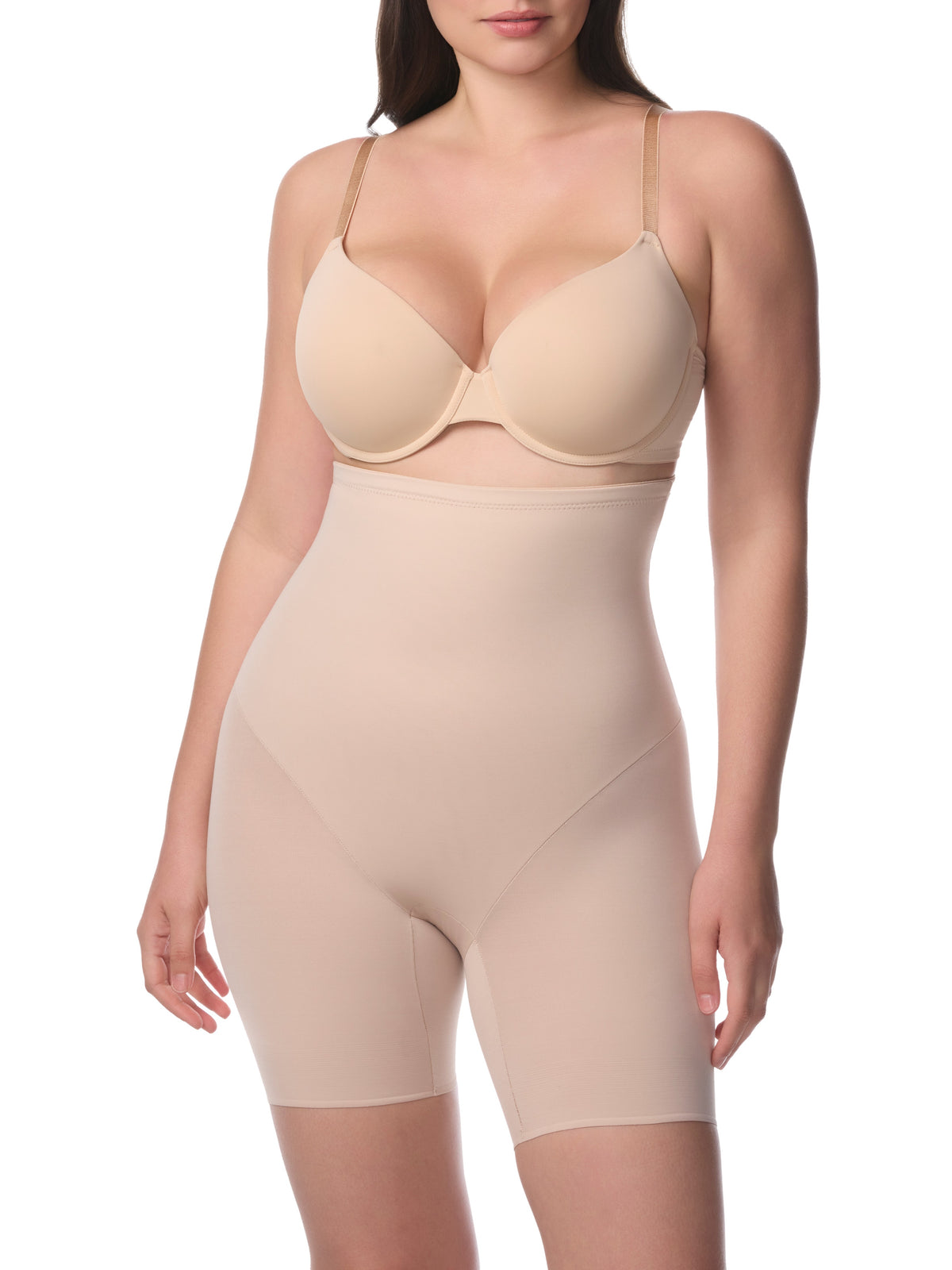 Woman wearing a beige shapewear garment on a white background