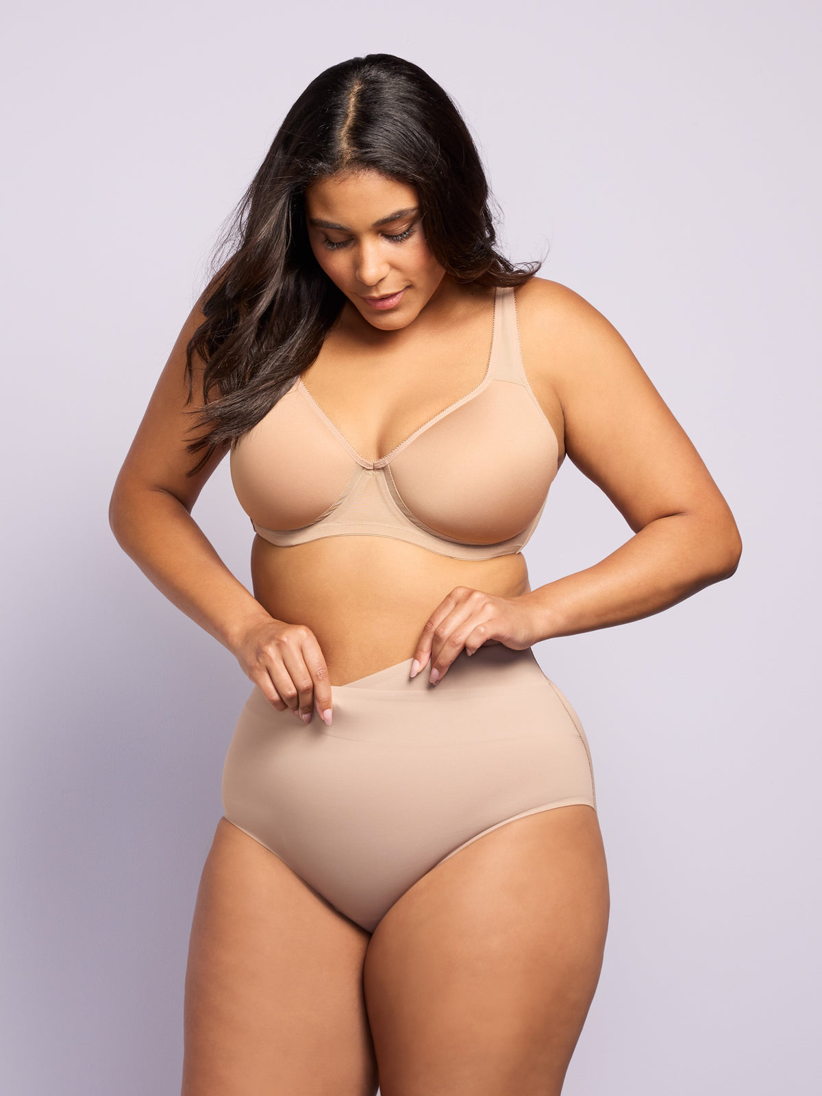 a woman wearing a nude tummy control brief all-groups