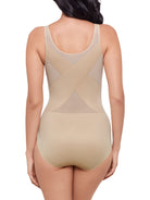 a woman wearing a nude shaping bodysuit body shaper