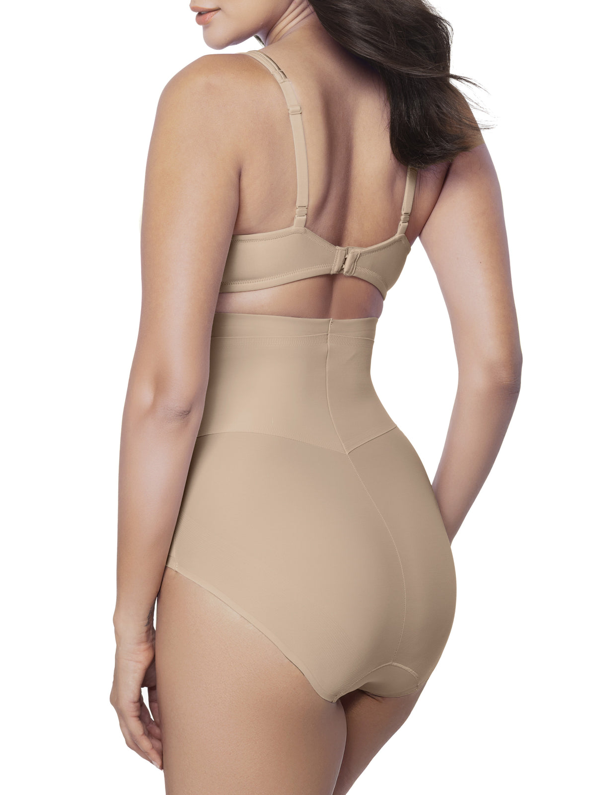 Woman wearing a beige shapewear brief on a white background