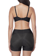 Black shapewear short on a model against a white background