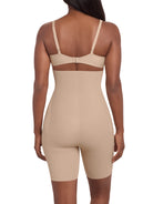 a woman wearing a beige high waisted tummy control thigh slimmer shaping short miraclesuit shapewear