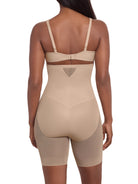 a woman wearing a beige sheer shapewear high waisted tummy control short thigh slimmer miraclesuit shapewear