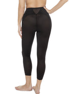 a woman wearing a black tummy control leggings shapewear