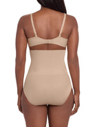 a woman wearing a beige high waisted tummy control brief control top panty miraclesuit shapewear