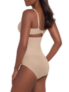 a woman wearing a beige high waisted tummy control brief control top panty miraclesuit shapewear