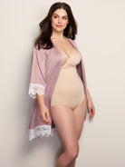 a woman wearing nude high waisted tummy control underwear and a mauve robe all-groups