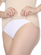 a close up of a silicone hem on a woman wearing a nude shaping cami