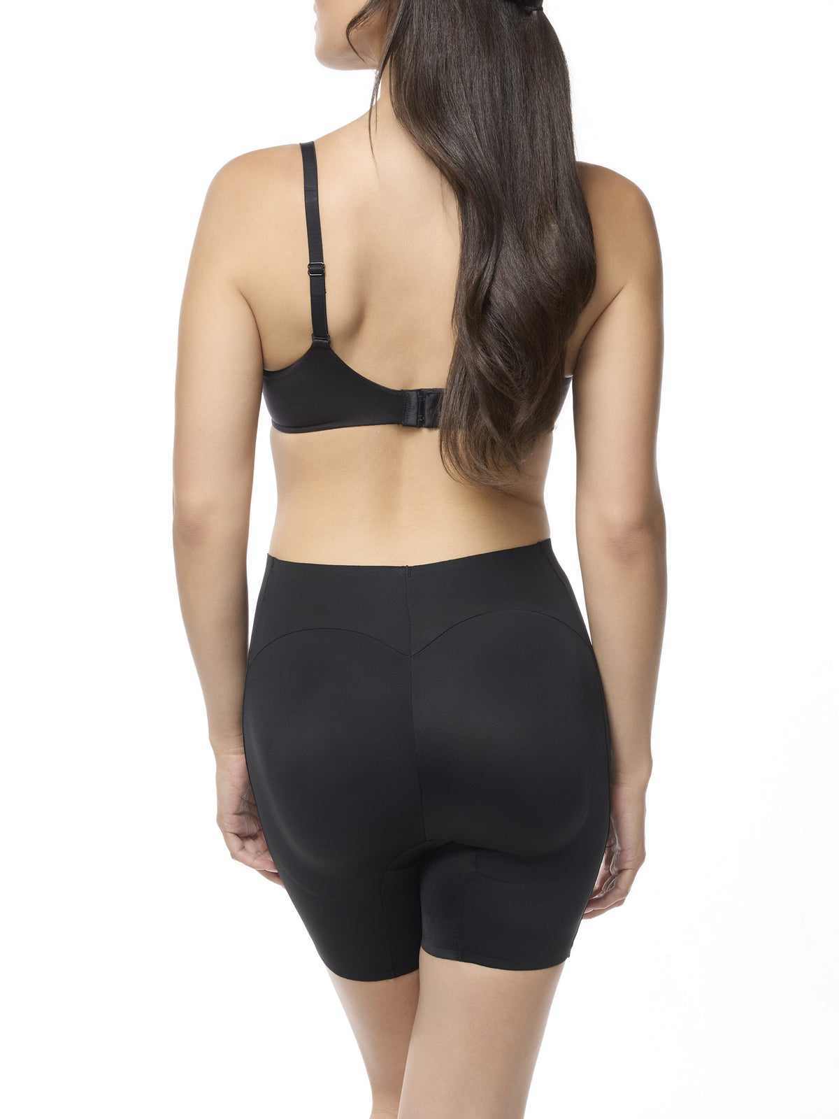 Woman wearing a black bra and shaping short on a white background