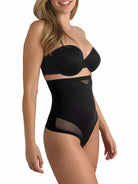 a woman wearing a black tummy control thong