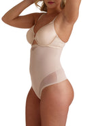 a woman wearing a nude tummy control thong