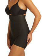 a woman wearing black high waisted tummy control shapewear shorts