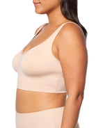 a woman wearing a nude bralette