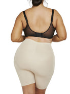 a woman wearing nude plus size tummy control shapewear shorts