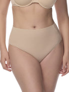 Beige underwear being worn by a person on a white background