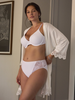 a  video of a woman wearing a white lingerie set with a lace robe in a bathroom all-groups